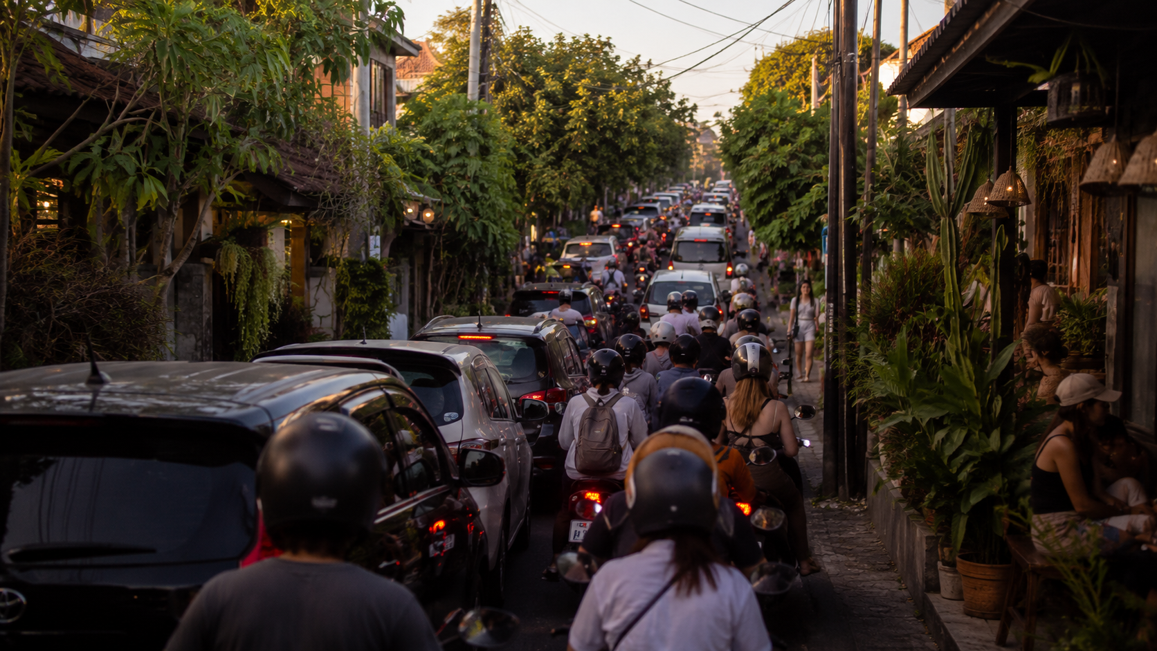 Planning a Short Bali Trip Around Traffic Cars and motorcycles in traffic on a narrow Bali road at sunset