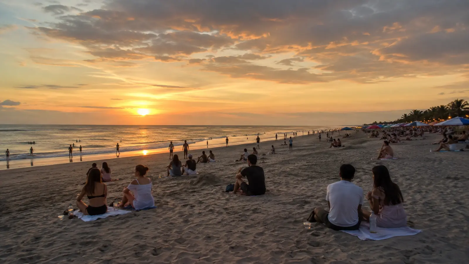 People pausing together at sunset on Seminyak Beach, Bali